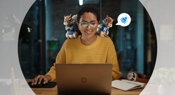 Woman developer in a yellow sweater working on laptop with two chipmunks, resembling AI-powered quality inspectors, standing on her shoulders. Chipmunks examining content displayed on screen, symbolizing AI’s role in enhancing quality assurance process.